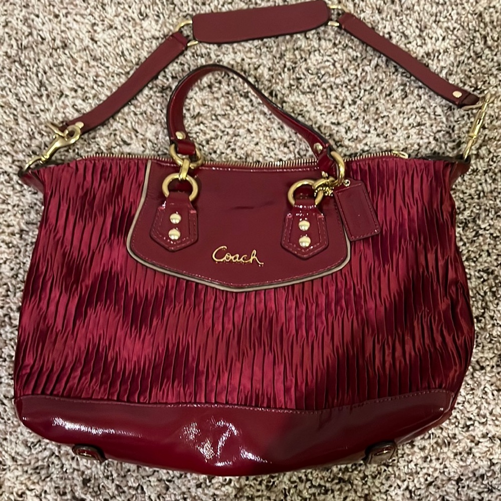 Coach-Burgundy red handbag w/shoulder & handle strap. Used, new condition. $45